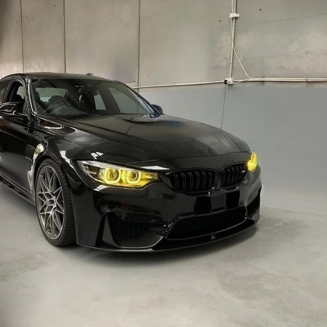 Black BMW car in a studio setting with a gray background